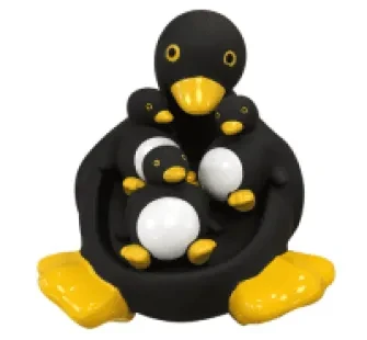 Black, yellow and white penguin, big penguin with 3 babies resting on tummy.