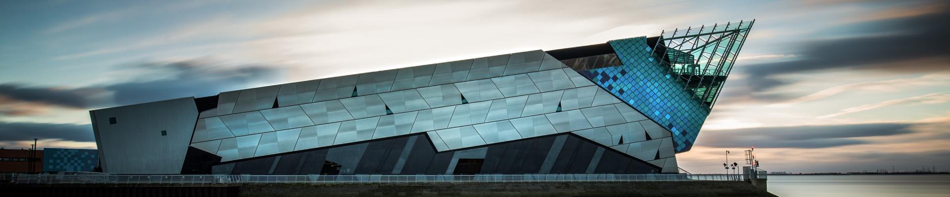 The Deep building exterior overlooking the Humber Estuary at dusk.